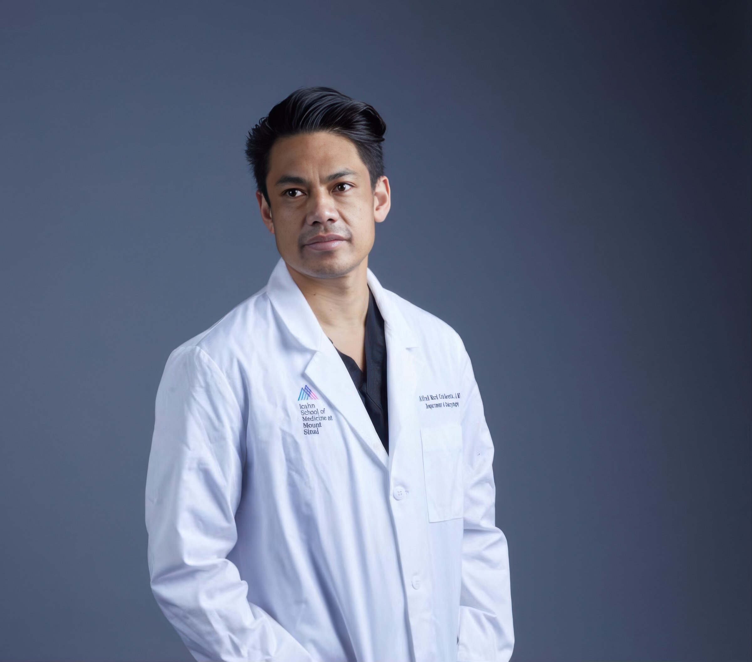 Studio portrait of Dr. Alfred Iloreta in Icahn School of Medicine at Mount Sinai white coat — Co-Director of Endoscopic Skull Base Surgery